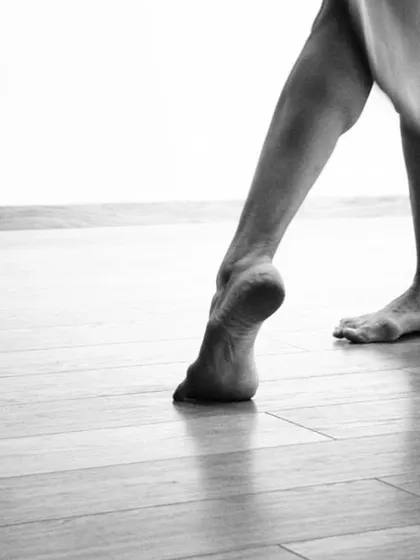 A close-up on the foot, the foundation of the dancer. This image, inspired by poetry, speaks to the grounding and strength required for a life in motion.