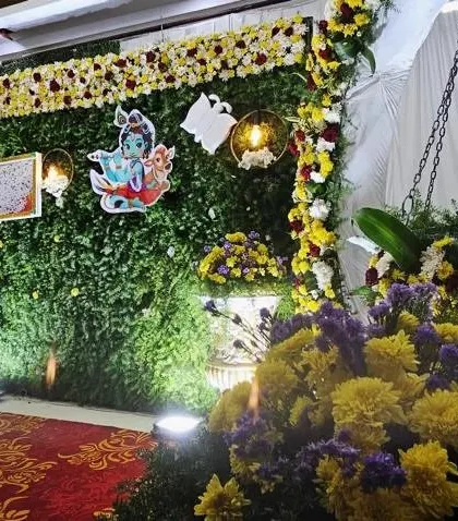 Another angle of the Krishna-themed naming ceremony, showing the cradle and the floral arrangements. The details create a festive and traditional atmosphere.