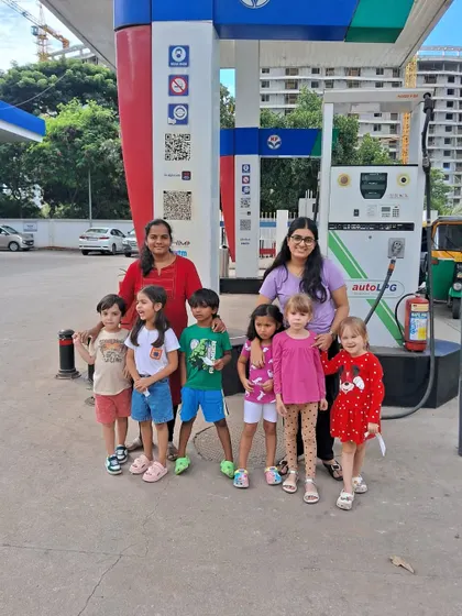 A group photo of our K1 class and their teachers at the gas station, documenting their fun field trip.
