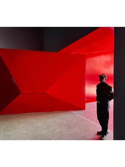 A bold, folded red metal form marks the entrance to the University Sports Center. This sculptural doorway creates a powerful sense of arrival and sets the tone for the dynamic and colorful interior spaces within.
