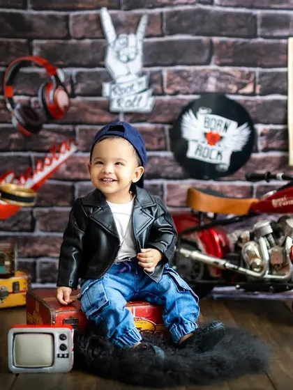 Born to be wild! This little dude is rocking his leather jacket and cool attitude in our fun, rock-and-roll themed studio setup.