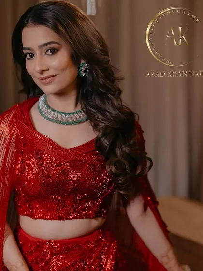 Glamour locks in a vibrant red outfit. The soft curls add a touch of romance to this bold and beautiful look.