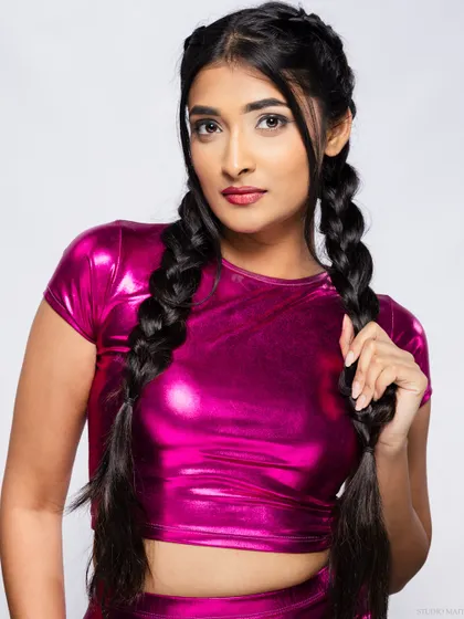 A confident portrait of the model in the metallic pink outfit.