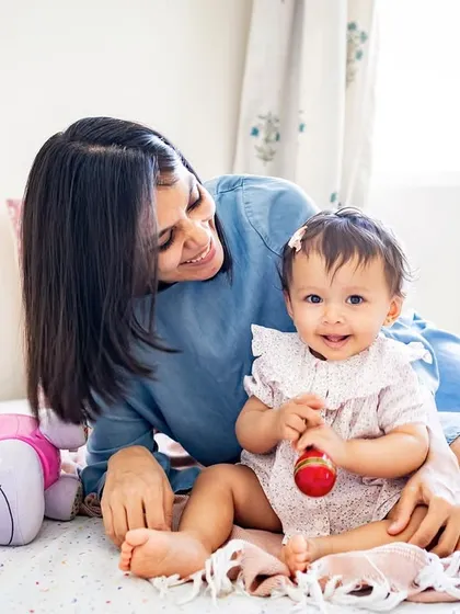A sweet mother-daughter moment during a lifestyle session. I love capturing these natural cuddles and playtime scenes on the bed.