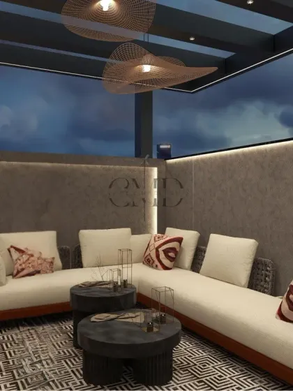 Plush L-shaped seating and sculptural wicker lighting create the perfect balance of elegance and ease for sunset gatherings.