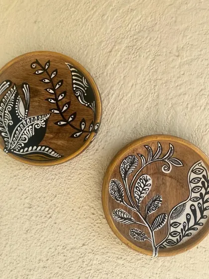 A pair of the black and white botanical plates, perfect for a minimalist yet artistic wall decor statement.