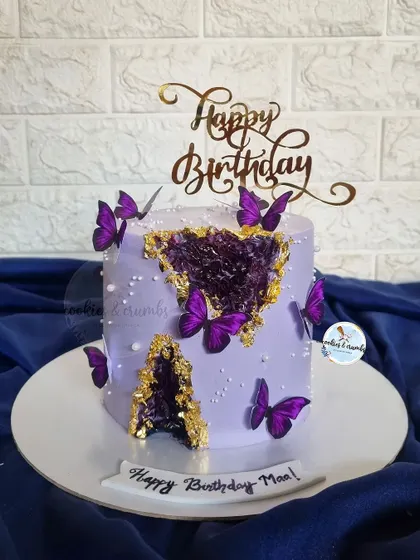 This purple geode cake is one of my bestsellers and personal favorites. The combination of the rich purple, sparkling crystals, gold leaf, and butterflies is just magical.