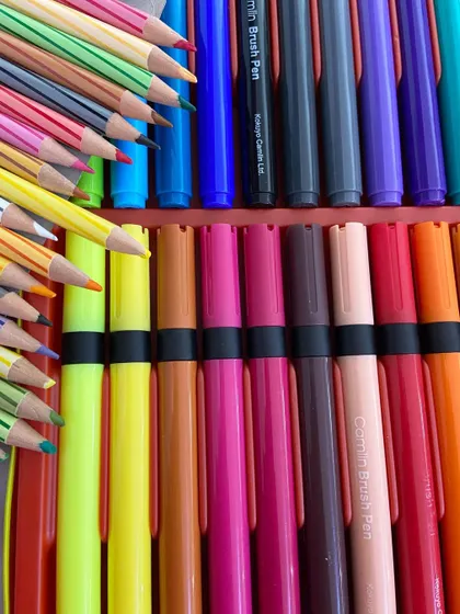 The tools of the trade. We guide students on using the right materials, from colored pencils to brush pens, for their illustrations.