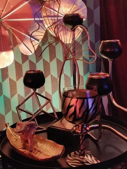 A close-up of the whimsical, enchanted forest decor, featuring metallic animal-print glasses and other quirky, detailed props.