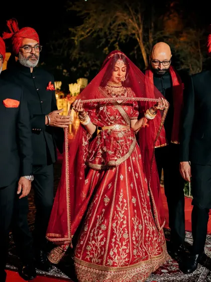 The bride's powerful entry, walking down the aisle with the father figures in her life.