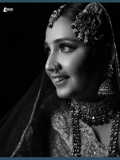 A classic black and white profile shot of bride Winnie, her happy smile captured in timeless monochrome.