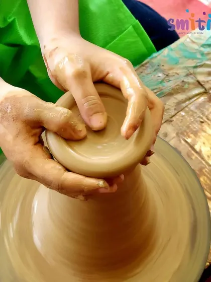 A close-up of hands shaping clay on the pottery wheel. This ancient craft connects children to a rich artistic heritage and provides a unique sensory experience.