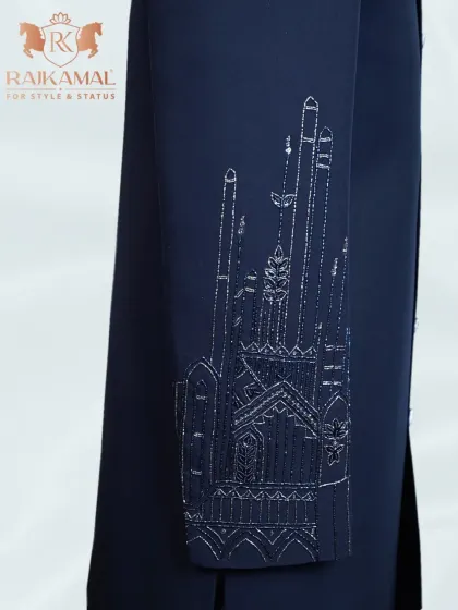 A view of the sleeve detail on the architectural embroidered jacket, showing the fine silver threadwork.