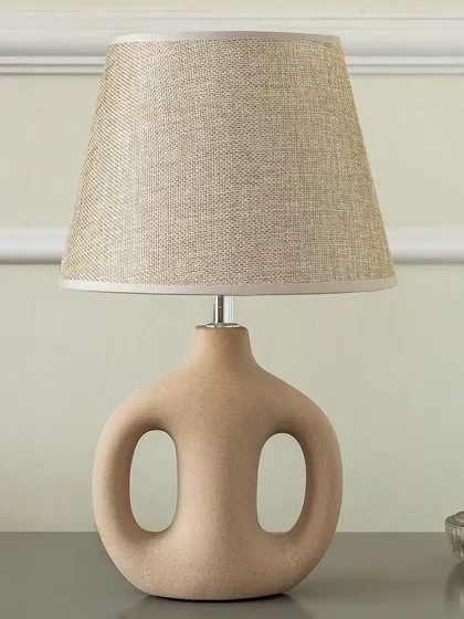 Lighting should also be art. This Artisan Loop Ceramic Table Lamp has a unique sculptural quality that makes it a decorative object even when turned off. The natural ceramic finish and simple shade make it a versatile piece for modern interiors.