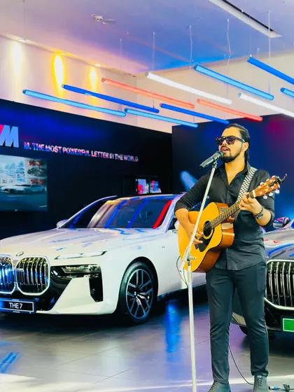 A full-length shot of my performance at the BMW showroom. This shows the complete solo setup, which is compact and professional, fitting seamlessly into any corporate space.