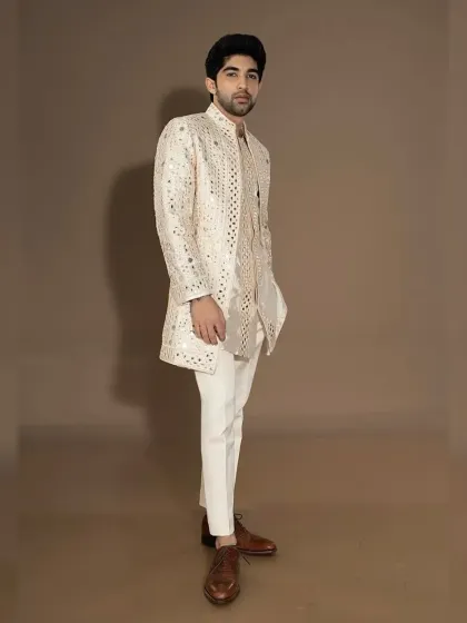 The full-length view of the ivory mirror-work jacket set, showcasing its luxurious and celebratory feel.
