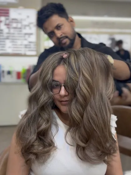 A stunning ash brown hair color transformation. The client looks beautiful and confident with her new cool-toned waves.