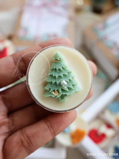 A close-up of the Christmas tree tealight, decorated with tiny gold flakes for a bit of sparkle.