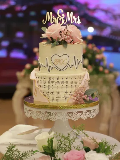 A "Medicine meets Melody" themed wedding cake for a doctor and a musician. The design features a heartbeat EKG line and musical notes, blending their two passions into one sweet story.