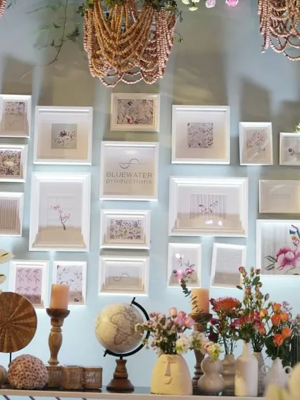 Another view of the gallery wall, where each frame was backlit to create a soft glow, showcasing the delicate beauty of the botanical art.