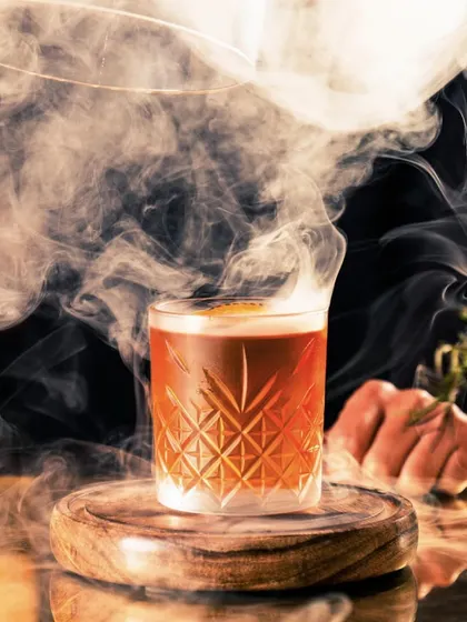 Let my cocktails be your passport to a realm of culinary delight. This smoky old-fashioned is where mixology takes center stage and flavor reigns supreme.