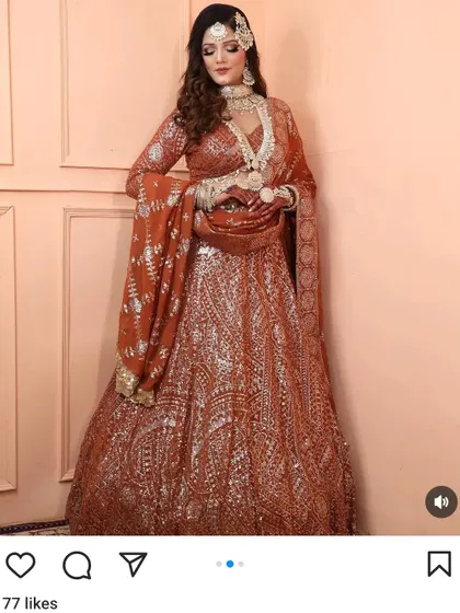 A full-length shot of a model in a rust-coloured sequin lehenga, paired with a custom Polki and pearl necklace set for a beautiful indo-western look.