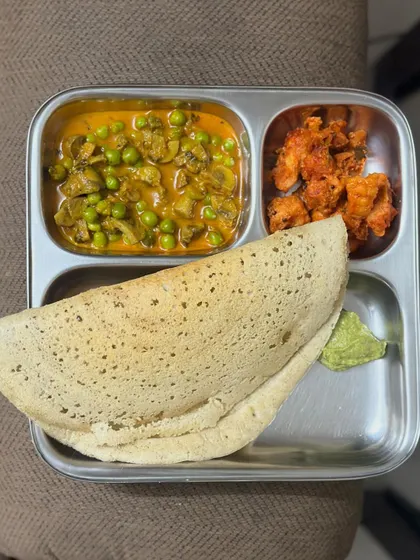A unique combination of dosa with a mushroom and green pea curry, and a side of prawn fry.