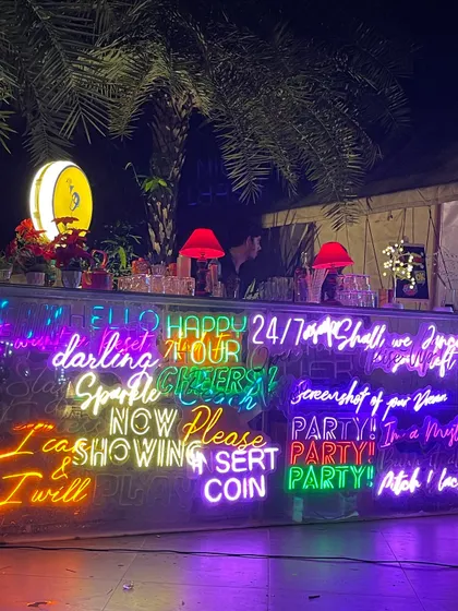 A bar should be the life of the party. For this birthday, I designed a custom bar wrapped entirely in vibrant, quirky neon signs to create an electric, high-energy atmosphere that guests loved.
