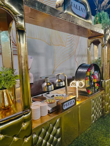 Another angle of the live pizza station, showing the fresh ingredients and toppings displayed for guests to see.