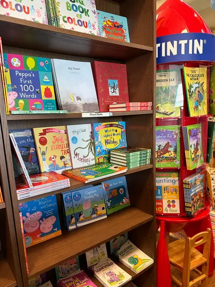 A view of our bookshelves, featuring popular series like Peppa Pig and Tintin, offering a wide selection for young readers.