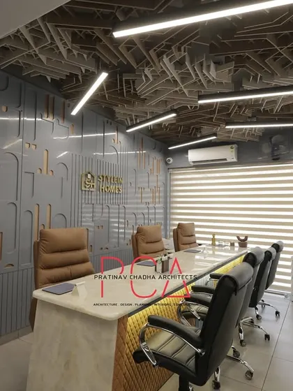 The StyleIn Homes conference room from a different angle, emphasizing the length of the table and the linear lighting above.