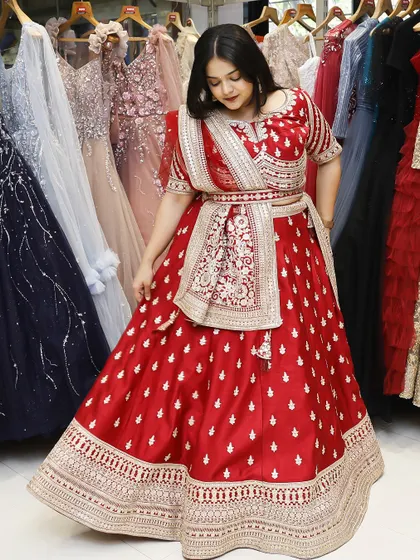 This is how you own your moment. A full view of a stunning red bridal lehenga, showcasing its flow and intricate design, perfect for making a grand entrance.