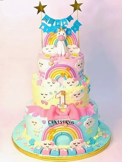 An exquisite three-tier unicorn-themed cake. This magical creation features vibrant pastel colors, edible unicorn figures, and enchanting rainbow details.