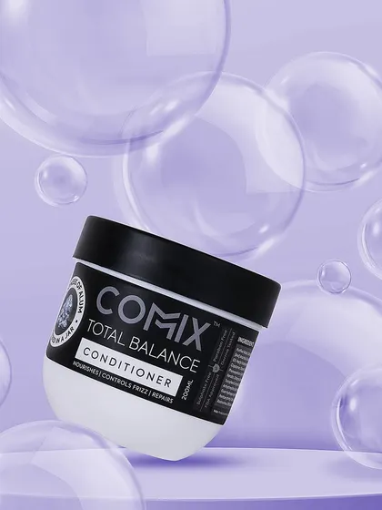 A fun, creative concept for a conditioner, showing it floating among purple bubbles. This playful and imaginative visual is designed to be eye catching and memorable on social media.