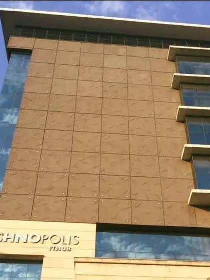 A detailed look at the facade of the Technopolis IT Hub. The grid-like pattern of the cladding provides a sense of order and scale to the structure.