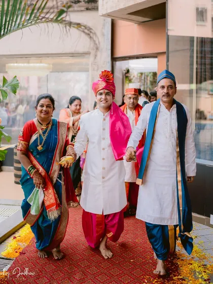The groom's entrance with his parents, a moment of family pride and joy.