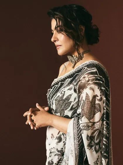 The profile view highlights the intricate patterns of this Torani saree and the soft, elegant hairstyle chosen for this look.