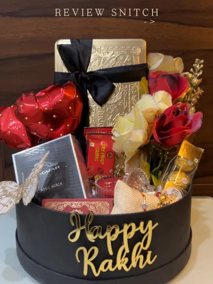A luxurious Rakhi hamper for a brother, featuring Jaguar perfume, gourmet snacks, and a 'Happy Rakhi' sign, all in a sleek black and gold theme.