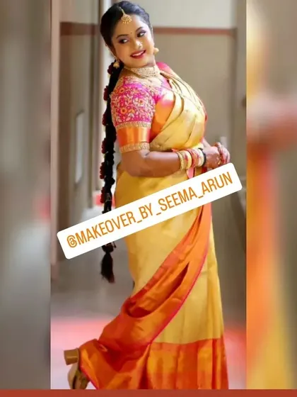 This full-length shot showcases a complete bridal look, including my professional saree draping service. The rich Kanchipuram silk saree is perfectly pleated to complement the makeup and the traditional long braid hairstyle, creating a timeless and elegant silhouette for her photoshoot.