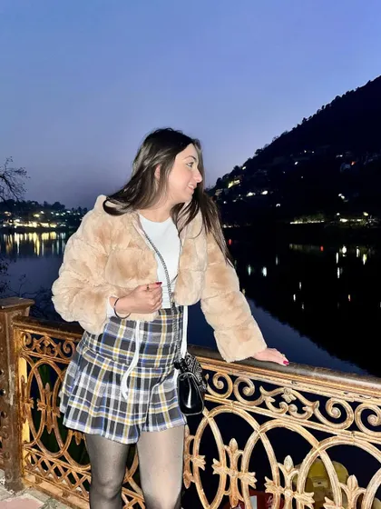 Posing by the serene Naini lake at dusk. This photo captures the beautiful twilight view and my cozy winter outfit, blending travel and fashion perfectly.