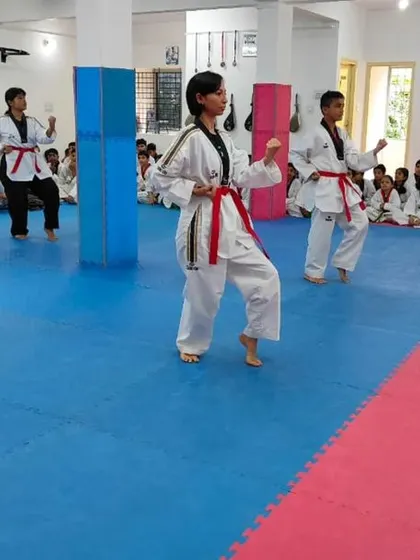 Students practice their form in front of the mirror.