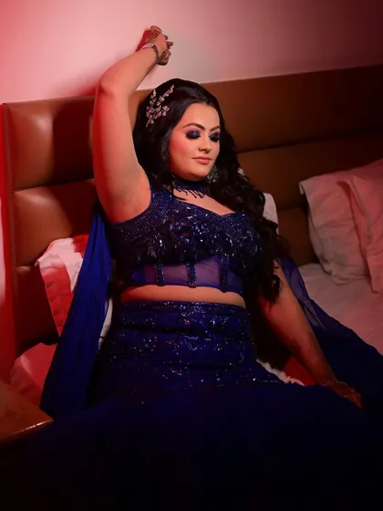 A full-length shot showing the stunning blue gown and the complete makeup and hair look. This is a perfect example of a modern, glamorous style for a sangeet or cocktail night.