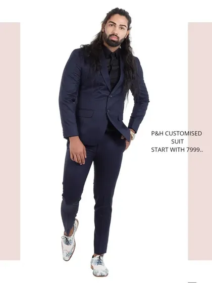A classic two-piece suit in a deep navy blue, a versatile and essential piece for any gentleman's wardrobe.