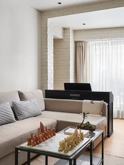 The informal sitting room in Zen House serves as a retreat for music and relaxation. The L-shaped sofa unfolds into a bed, making this versatile room a jam space one day and a guest room the next.