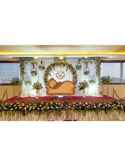 A wide shot of the engagement stage with a floral arch.