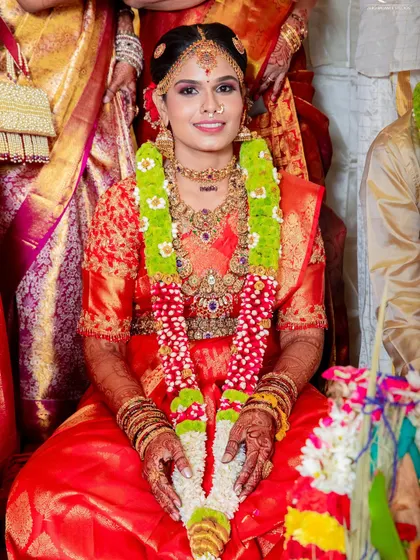 These photos capture the beautiful moments of a traditional wedding. The bride's red silk saree is draped to stay perfect through all the ceremonies, from sitting at the mandap to seeking blessings.