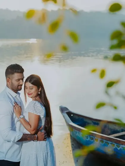 A romantic portrait of the couple by a boat, with the soft light of the setting sun creating a beautiful atmosphere.