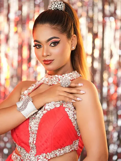 A vibrant and energetic high-fashion look in red. The winged eyeliner and bold red lip are classic glam elements.