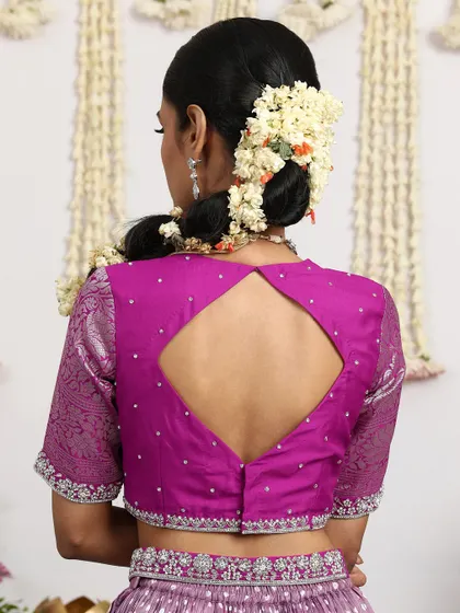 The back of the magenta blouse reveals a modern diamond-shaped keyhole design.