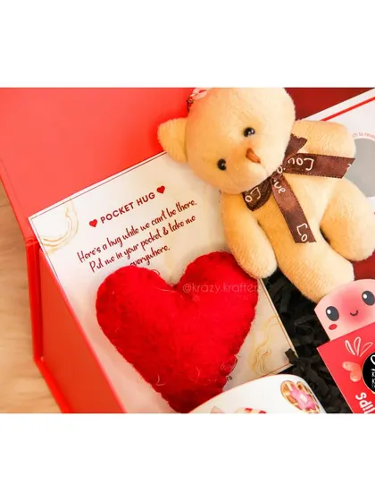 A close-up of the adorable 'pocket hug' and teddy bear from our Valentine's week hamper.